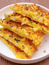 Corn fritters with black sesame seeds on a white plate