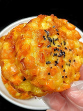 Cheesy bread with black sesame seeds on a white plate