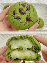 Green cookies with white filling held by a hand, showing both whole and cut-open views.