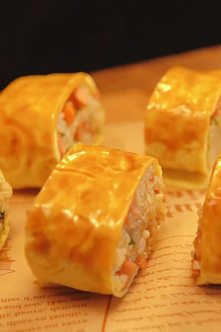 Rolls of sushi with a golden-brown exterior on a newspaper background