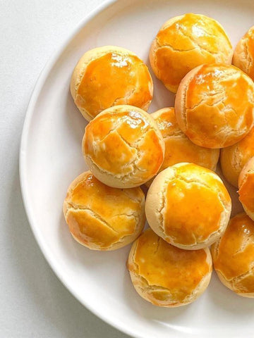 Plate of small, round, golden-brown pastries on a white plate.