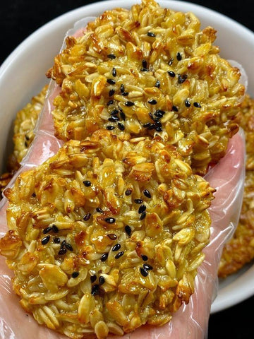 Oatmeal cookies with black seeds on a white plate
