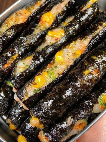 Rolled sushi with vegetables and shrimp in a metal container