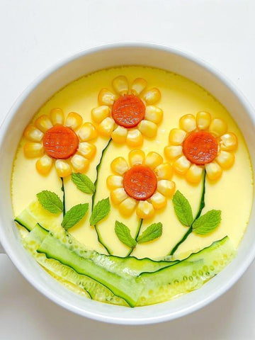 Egg dish with vegetable flowers on a white background
