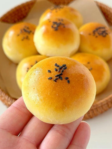 Baked goods with sesame seeds on a woven basket