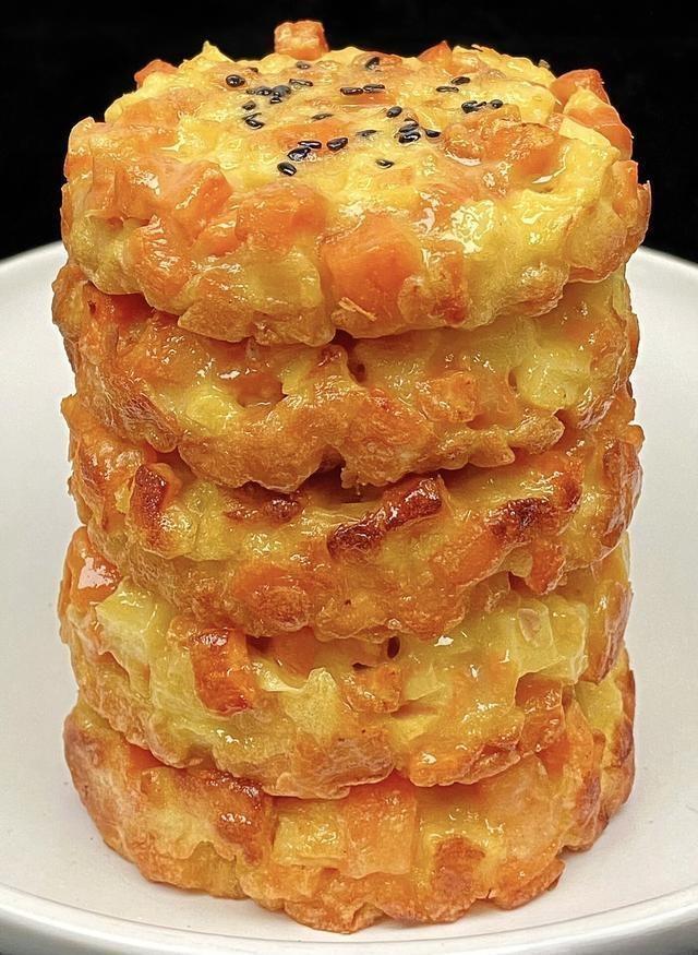 Stack of golden-brown fried snacks on a white plate with a black background